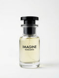 Perfume bottle labeled 'Imagine' by Elesscents on a white background